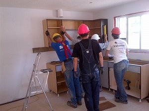 Martha and crew installing kitchen cabinets